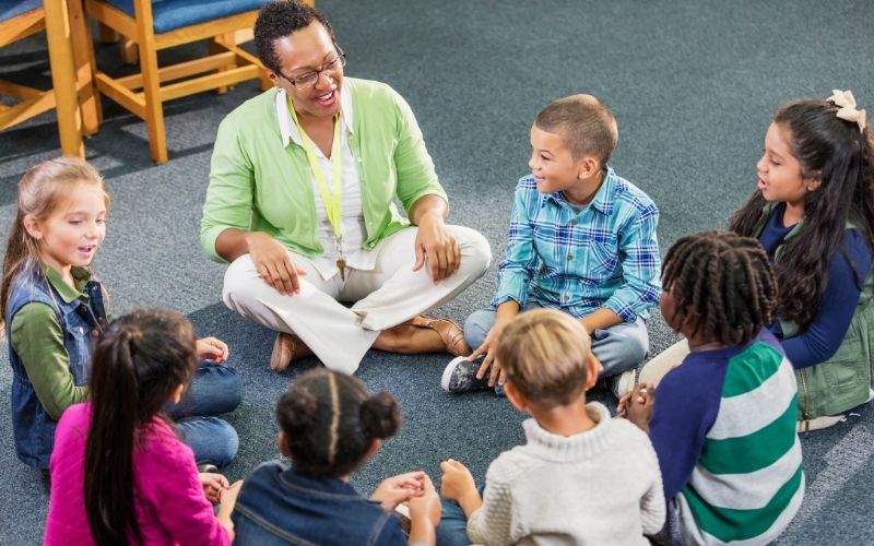 Students sit in a circle in the classroom