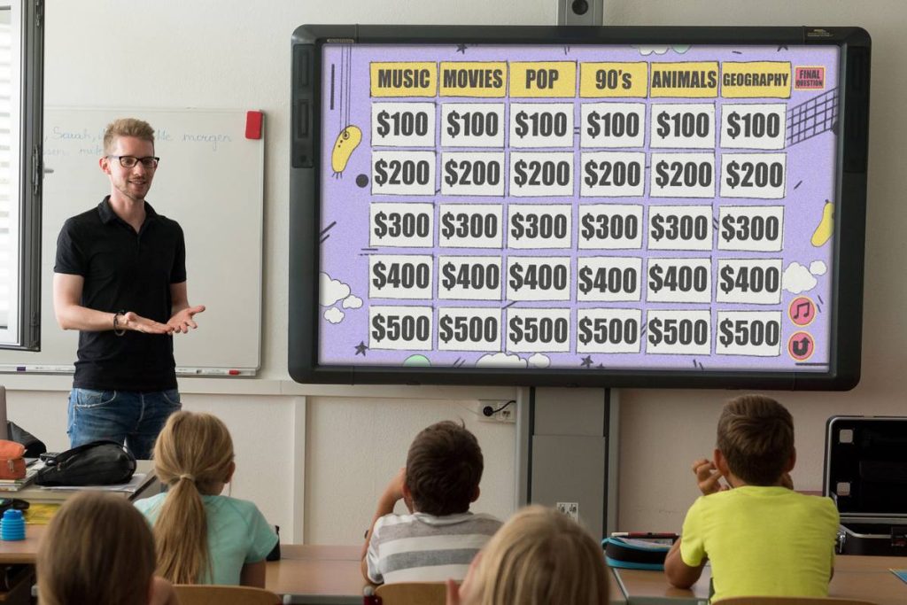 Teacher plays classroom Jeopardy on a smartboard